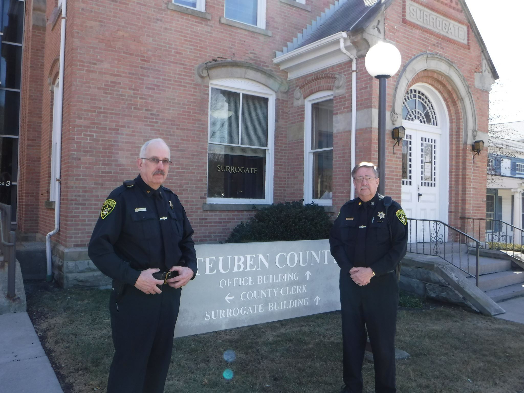 Barrett and Scott standing outside of the office building