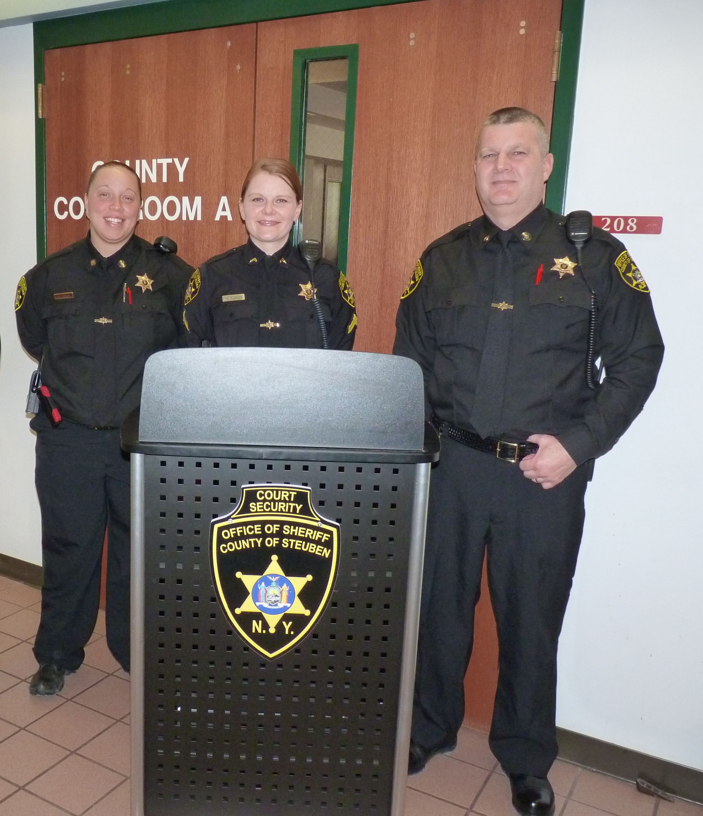 Three Officers standing at podium